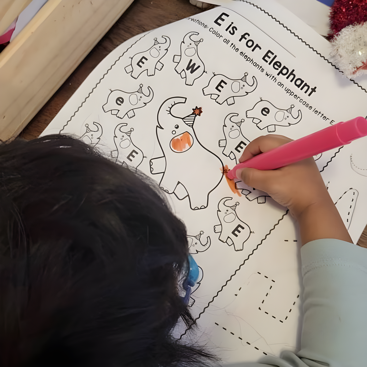 Alphabet worksheet being completed with a marker